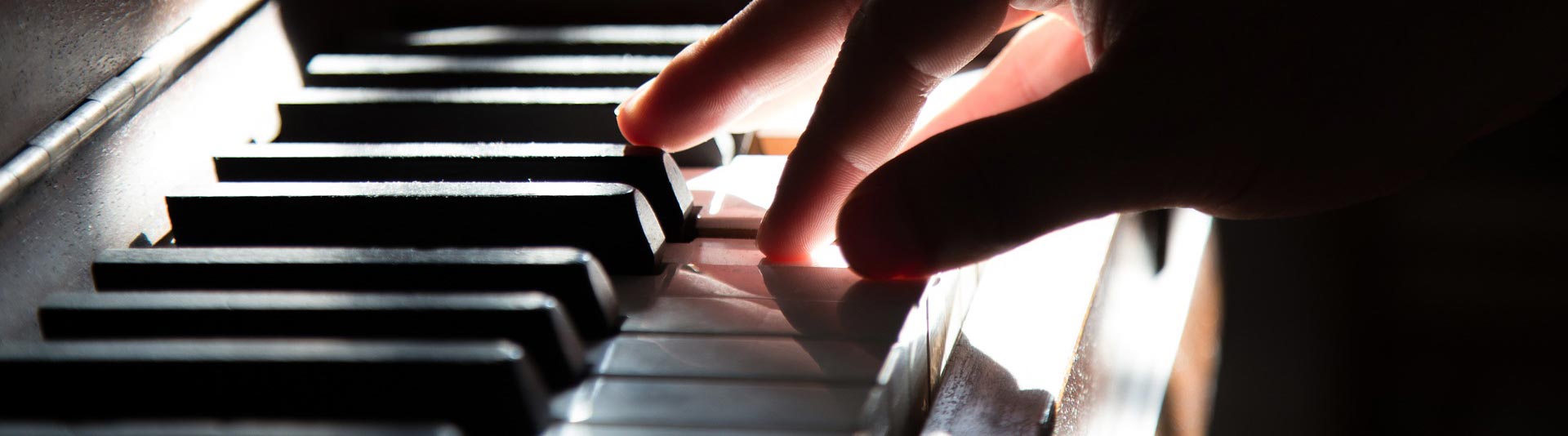 Hand on piano keys